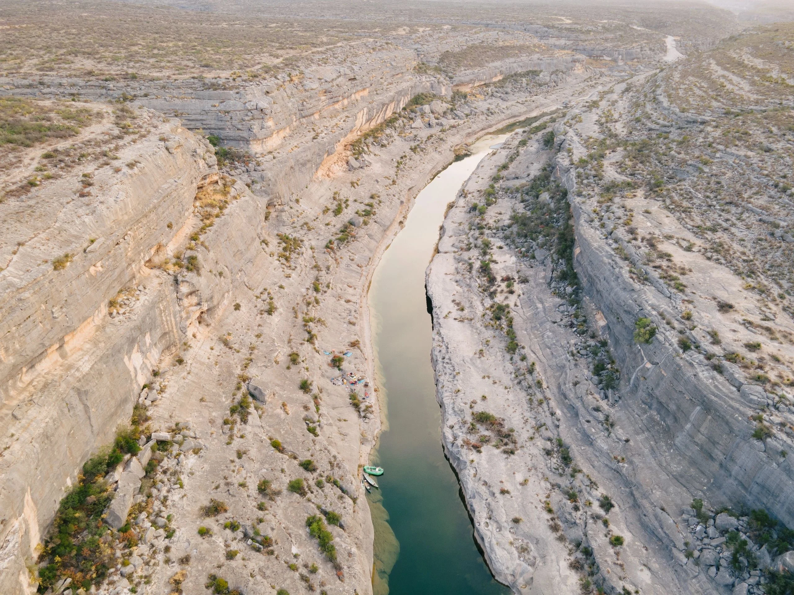 Aerial down a limestone canyon with the river snaking through it