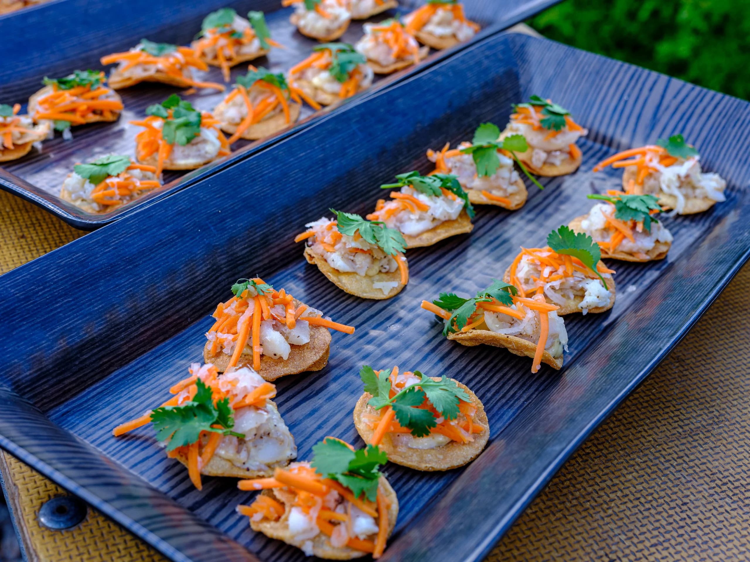 Tray of plated appetizers garnished with cilantro