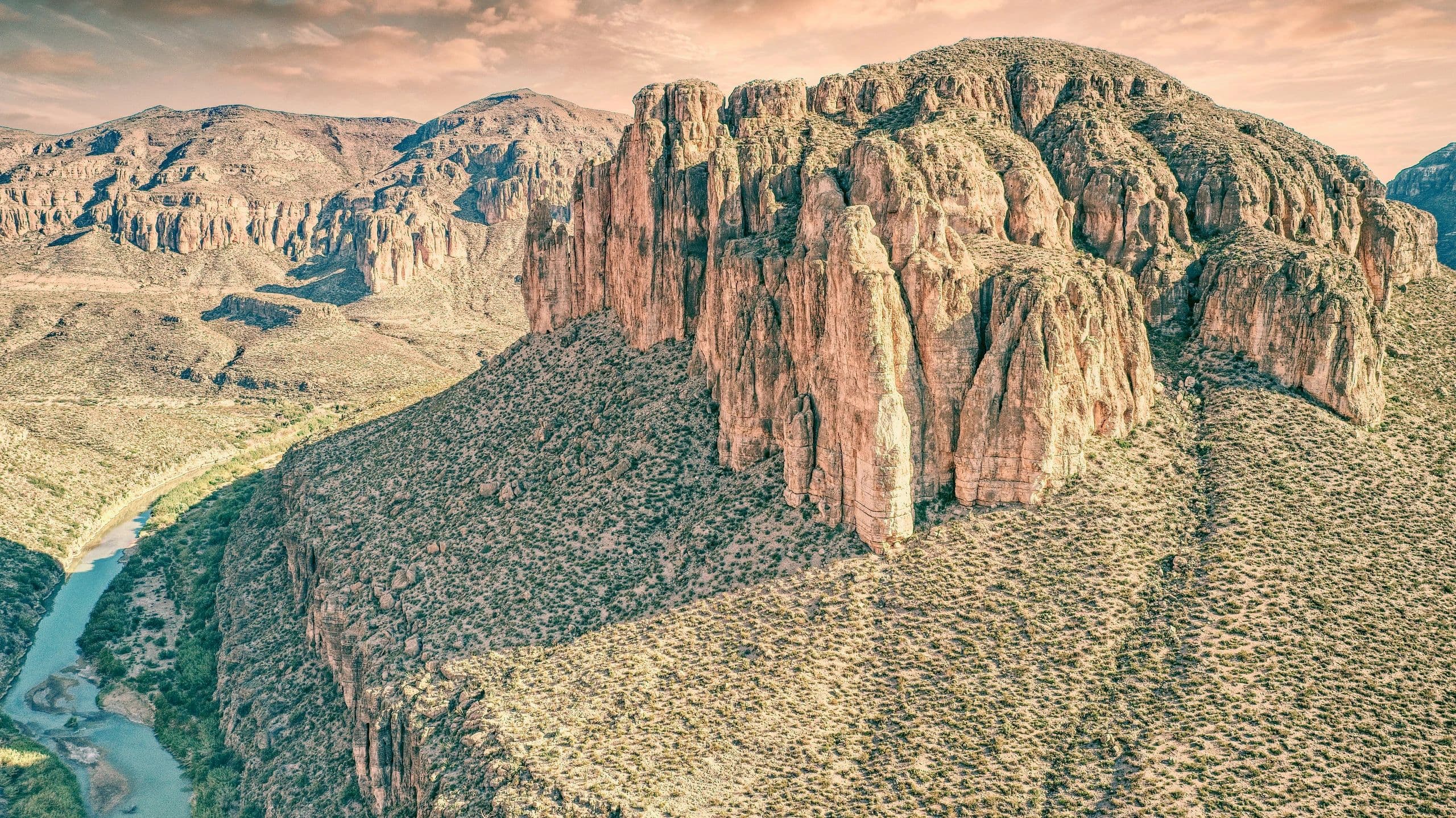 Aerial of a limestone mesa and cliff line with the river below