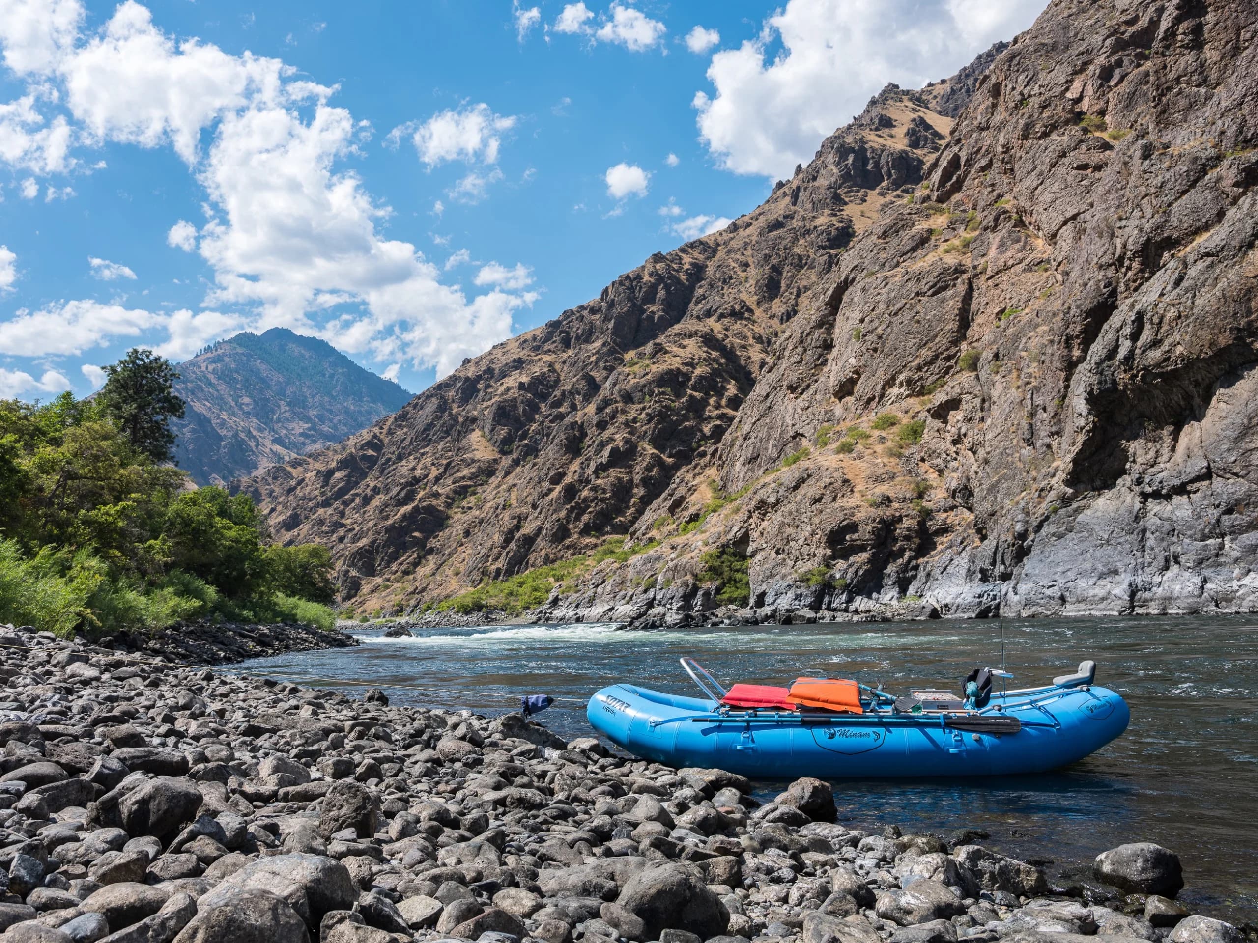 Blue raft beached on cobbles in Hells Canyon